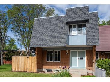 Charming two-story home with brick facade, gray roof, and well-maintained front yard at 11651 Pennsylvania St, Northglenn, CO 80233