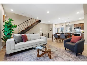 Bright and modern living space with contemporary furniture, open to dining and kitchen areas at 4469 Tennyson St # 15, Denver, CO 80212
