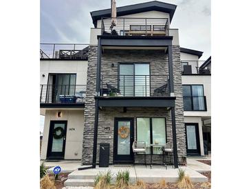Modern townhome featuring private balconies and rooftop patio, perfect for outdoor living at 1472 Yates St, Denver, CO 80204