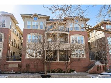 Chamberlin Heights features a red brick facade with multiple balconies and symmetrical windows, offering a classic and inviting look at 1489 Steele St # 310, Denver, CO 80206