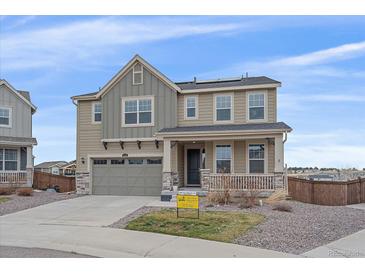 Inviting two-story home with a covered porch, a two-car garage, and xeriscaping at 1202 Lance Leaf Ct, Elizabeth, CO 80107