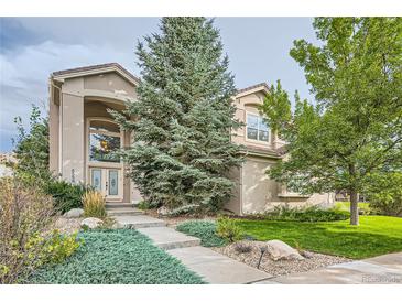 Inviting two-story home with a well-manicured lawn and attractive landscaping at 6598 S Telluride St, Aurora, CO 80016