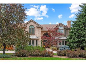 Brick two-story house with landscaped yard and circular driveway at 5320 S Race Ct, Greenwood Village, CO 80121