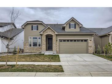 Charming two-story home featuring stone accents, a two-car garage, and well-maintained lawn at 3140 Newfound Lake Rd, Berthoud, CO 80513