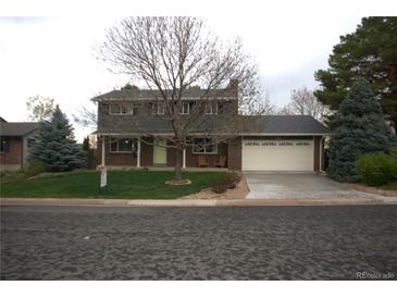 Charming two-story brick home featuring a well-maintained lawn and a spacious two-car garage at 978 Mercury Cir, Lone Tree, CO 80124