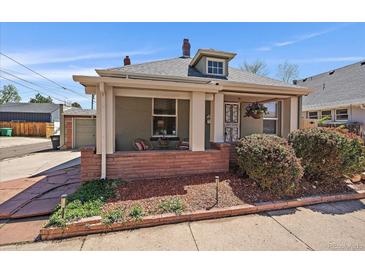 Charming home featuring a cozy front porch with inviting curb appeal and mature landscaping at 3420 Julian St, Denver, CO 80211
