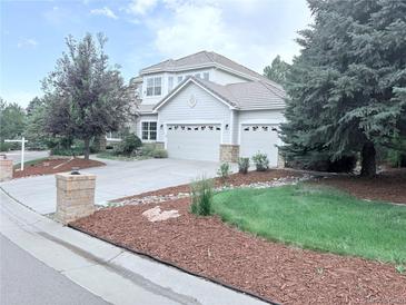 Charming two-story home featuring a three-car garage and well-manicured landscaping at 22019 E Arbor Dr, Aurora, CO 80016