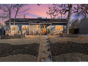 Updated ranch home with gray exterior, stone accents, and landscaped yard at 3088 S Grape Way, Denver, CO 80222