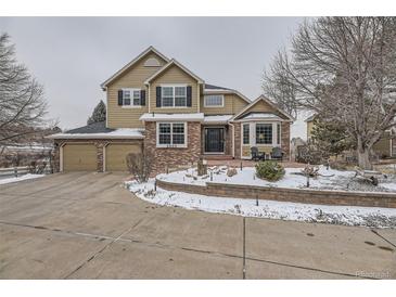 Charming two-story home featuring a well-maintained front yard and attached two car garage at 2522 W Dry Creek Ct, Littleton, CO 80120