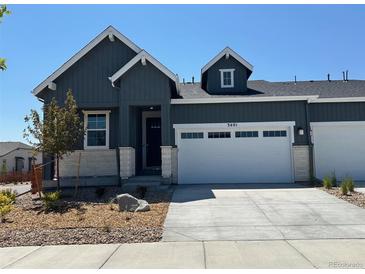 Charming one-story home with grey siding, white trim, a two-car garage, and beautifully landscaped front yard at 3401 N Denali St, Aurora, CO 80019