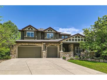 Stunning two-story home featuring stone accents, a three-car garage, and a well-maintained front yard at 14118 Whitney Cir, Broomfield, CO 80023