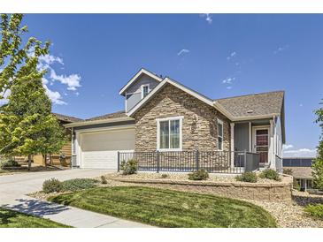 Beautiful two-story home with stone accents, well-manicured lawn, and inviting curb appeal at 12685 W Montane Dr, Broomfield, CO 80021