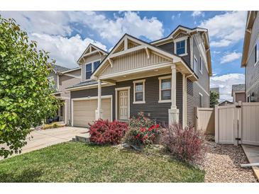 Charming two-story home featuring neutral siding, a two-car garage, and beautifully landscaped front yard at 4414 Walden St, Denver, CO 80249