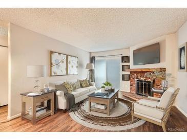 Bright living room features a fireplace and sliding door access to a patio at 14590 E 2Nd Ave # 304B, Aurora, CO 80011