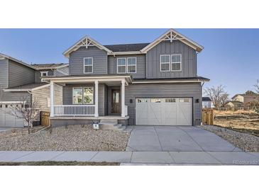 Charming two-story home with a covered front porch and attached two-car garage at 2670 E 102Nd Pl, Thornton, CO 80229