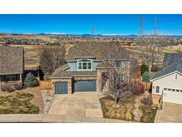 Beautiful two-story home with a well-manicured lawn, complemented by a two car garage and mountain views at 16333 Prairie Farm Cir, Parker, CO 80134