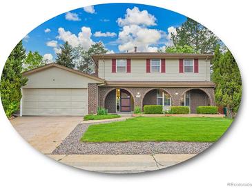 Charming two-story home featuring a manicured lawn, brick accents, and a spacious attached garage at 4670 E Euclid Cir, Centennial, CO 80121