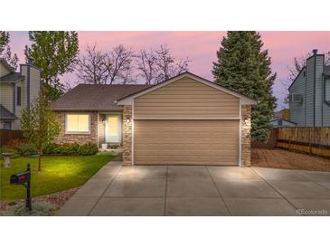 Charming single-Gathering home featuring a well-manicured lawn and attached two car garage at 9960 Garland Ln, Broomfield, CO 80021