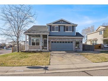 Charming two-story home with a well-manicured lawn and a two-car garage in a suburban neighborhood at 5796 E 129Th Pl, Thornton, CO 80602