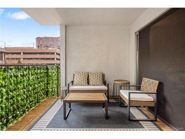Inviting balcony featuring outdoor seating and privacy greenery, perfect for relaxing outdoors at 2 N Adams St # 108, Denver, CO 80206