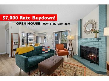 Inviting living room boasts a fireplace, comfortable seating, and access to outdoor space at 8378 S Upham Way # B305, Littleton, CO 80128