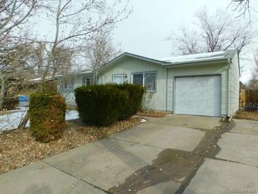 Ranch-style home with attached garage and well-maintained landscaping at 11621 E Ada Pl, Aurora, CO 80012