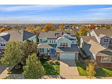 Inviting two-story home featuring manicured lawn, two car garage, and mountain views at 6317 Ruby Hill Dr, Erie, CO 80516