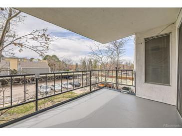 A cozy balcony with black wrought iron railings provides a private outdoor space with neighborhood views at 2325 S Linden Ct # 201, Denver, CO 80222