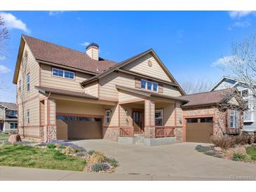 Charming two-story home featuring a three-car garage, stone accents, and a covered front porch at 4236 Frederick Cir, Longmont, CO 80503