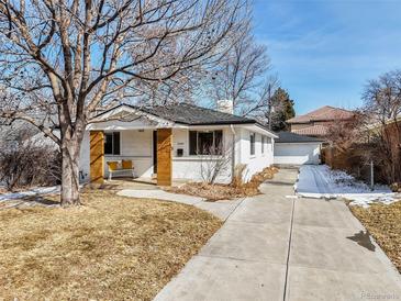 Charming home with a well-maintained front yard, a long driveway and beautiful curb appeal at 3180 S Albion St, Denver, CO 80222