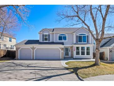 Charming two-story home with a three-car garage and well-maintained landscaping at 8441 Urban Ct, Arvada, CO 80005