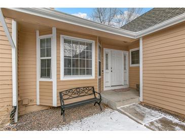 Inviting front entrance with white door, bay window and bench, perfect for a cozy and charming welcome at 13040 W 63Rd Pl # A, Arvada, CO 80004