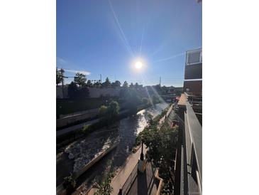 Balcony view of a rushing river on a sunny day, adding natural beauty to the property at 1438 Little Raven St # 306, Denver, CO 80202