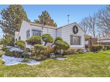 Charming home featuring a well-maintained lawn and beautiful landscaping at 4780 Milwaukee St, Denver, CO 80216