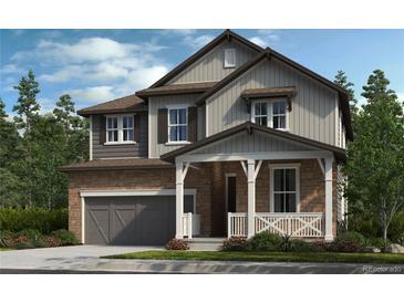 Charming two-story home with stone and siding exterior, covered porch, and well-manicured lawn at 15468 Kearney St, Brighton, CO 80602