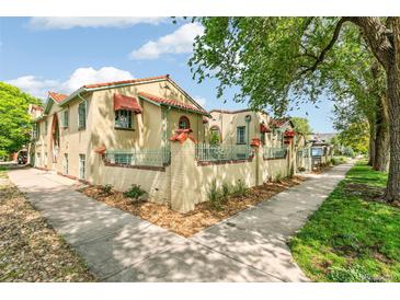 Charming apartment building with a unique facade and lush landscaping along the sidewalk at 485 S Logan St # 10, Denver, CO 80209