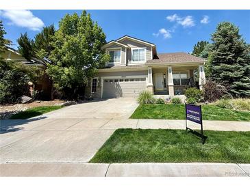 Charming two-story home with a well-manicured front yard and attached two car garage at 16063 E 106Th Ct, Commerce City, CO 80022