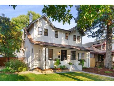 Charming two-story home with a well-manicured front yard and inviting curb appeal at 1815 S Ogden St, Denver, CO 80210