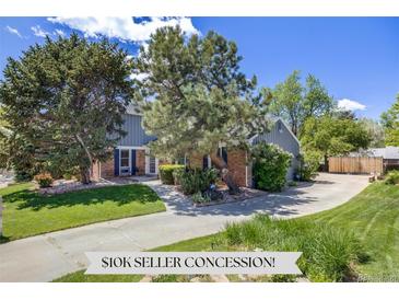 Charming two-story home with brick accents, lush landscaping, and a spacious driveway at 2773 S Macon St, Aurora, CO 80014