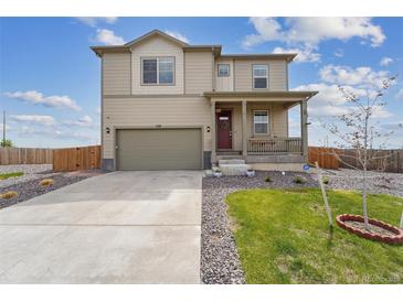 Charming two-story home featuring a covered front porch and attached two-car garage at 2201 Monte Vista St, Fort Lupton, CO 80621