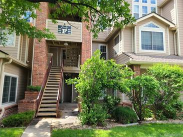 Inviting exterior of a multi-story condo building with well-maintained landscaping and a staircase leading to the entrance at 4760 S Wadsworth # 301, Littleton, CO 80123