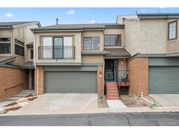 Charming townhome featuring a two-car garage and inviting front porch at 7450 W Coal Mine Ave # D, Littleton, CO 80123