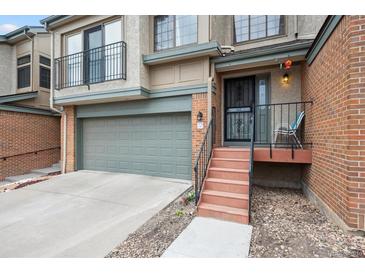 Inviting front entrance of townhome featuring steps to the front door and a garage at 7450 W Coal Mine Ave # D, Littleton, CO 80123
