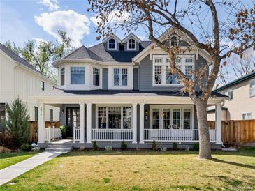 Charming gray two-story home with a welcoming front porch and well-manicured lawn at 2475 S Adams St, Denver, CO 80210