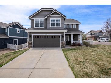 Charming two-story home with a two-car garage, landscaped yard, and classic curb appeal at 4307 Beautiful Cir, Castle Rock, CO 80109