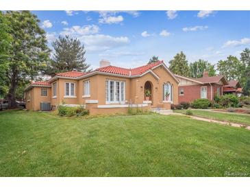Charming stucco home with a red tile roof and a well-maintained lawn at 1295 S Downing St, Denver, CO 80210