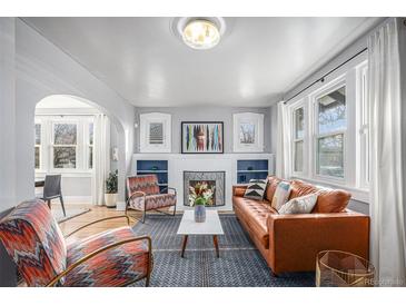 Bright living room with fireplace and comfortable seating at 2236 Jasmine St, Denver, CO 80207