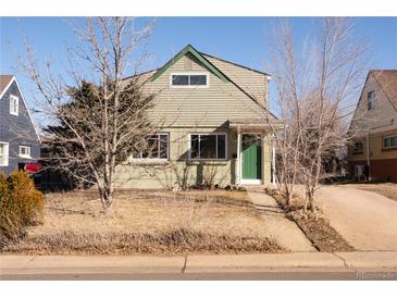 Light green two-story home with an inviting front exterior and walkway surrounded by bare trees at 3640 Elm St, Denver, CO 80207