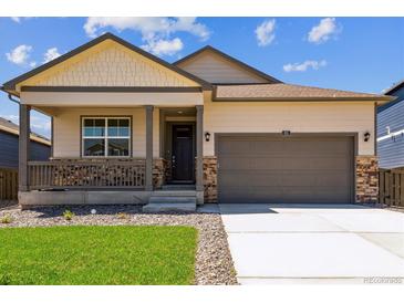 Charming single-Gathering home with a covered front porch and a two-car garage, showcasing great curb appeal at 845 Leeward St, Lochbuie, CO 80603