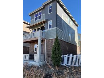 Beautiful exterior view featuring a well-maintained yard and a covered porch, perfect for relaxing outdoors at 2383 S Troy Ct, Aurora, CO 80014